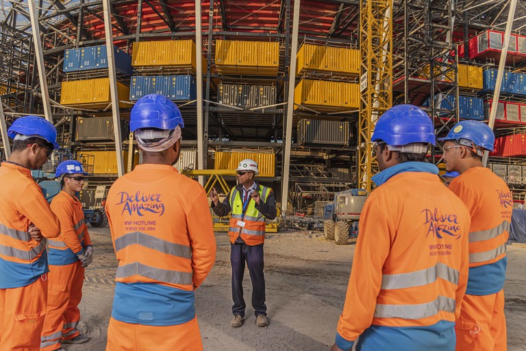 A contractor with workers at the Ras Abu Aboud Stadium